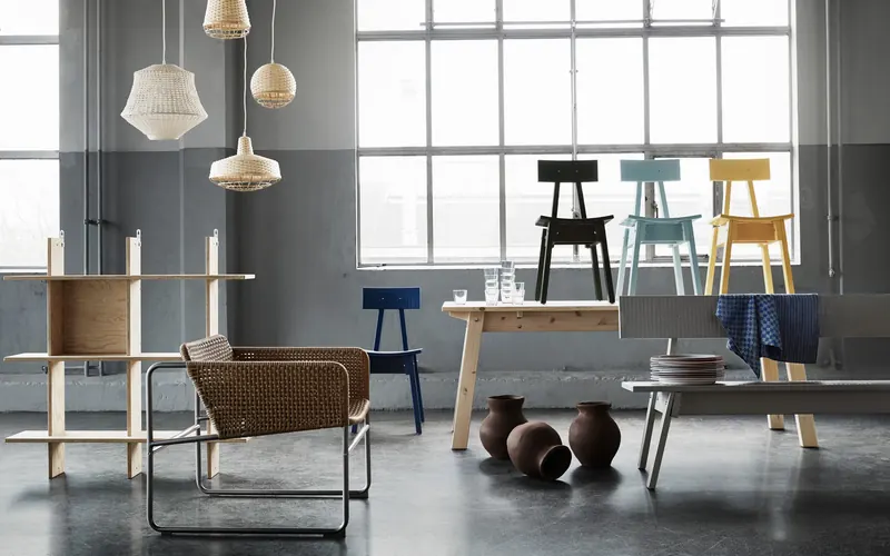 IKEA room set with rattan chair, shelving and pendant lights